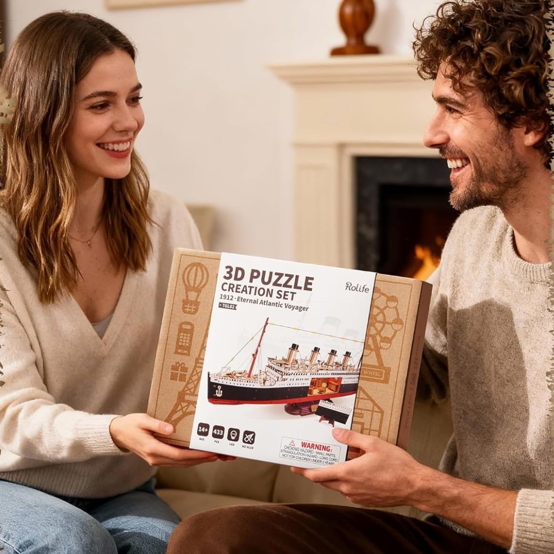 A couple admiring a 3D puzzle kit by the fire