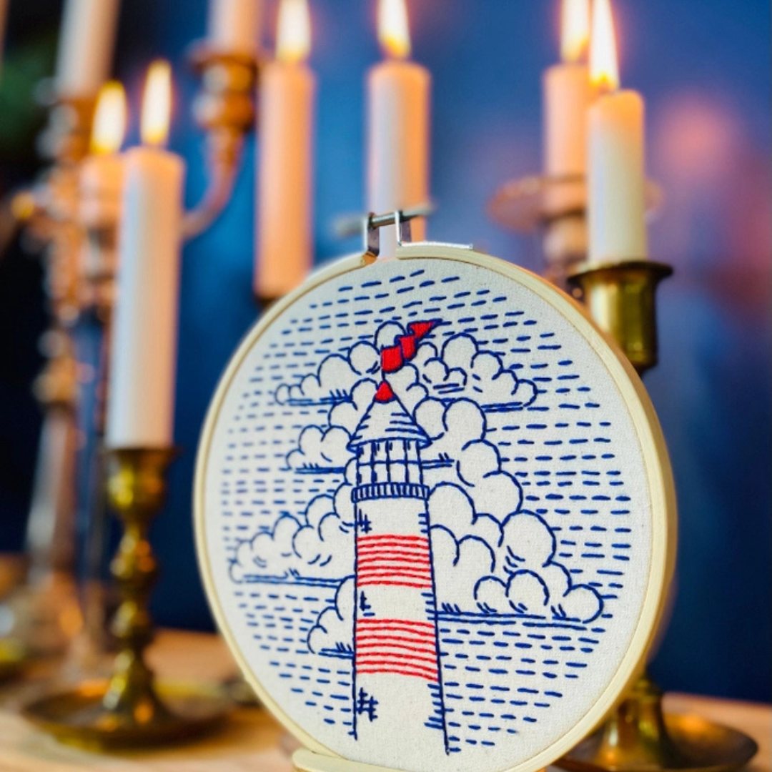 An embroidery kit lit by candlelight